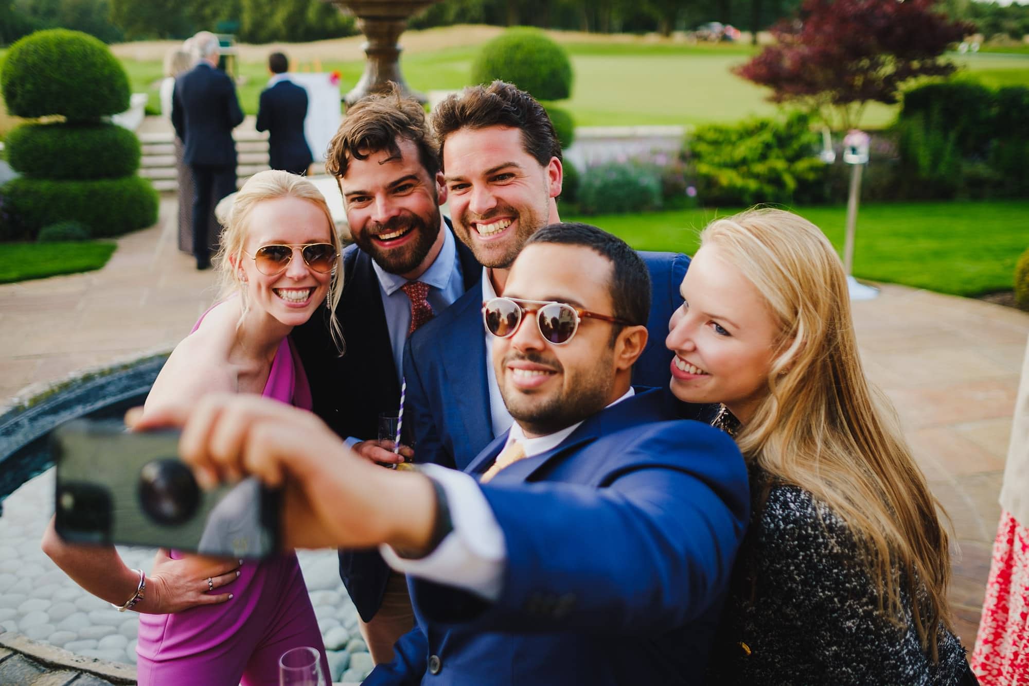 guests snap a selfie together at a Queenwood Golf Course event