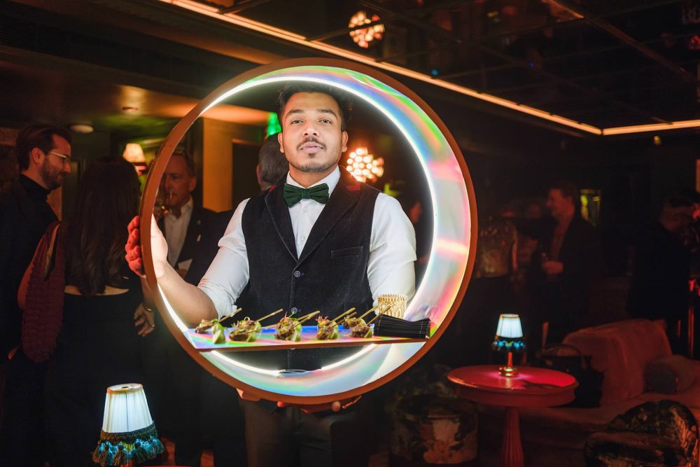 Caterers presenting canapés to guests at a private event in Dear Darling, Mayfair