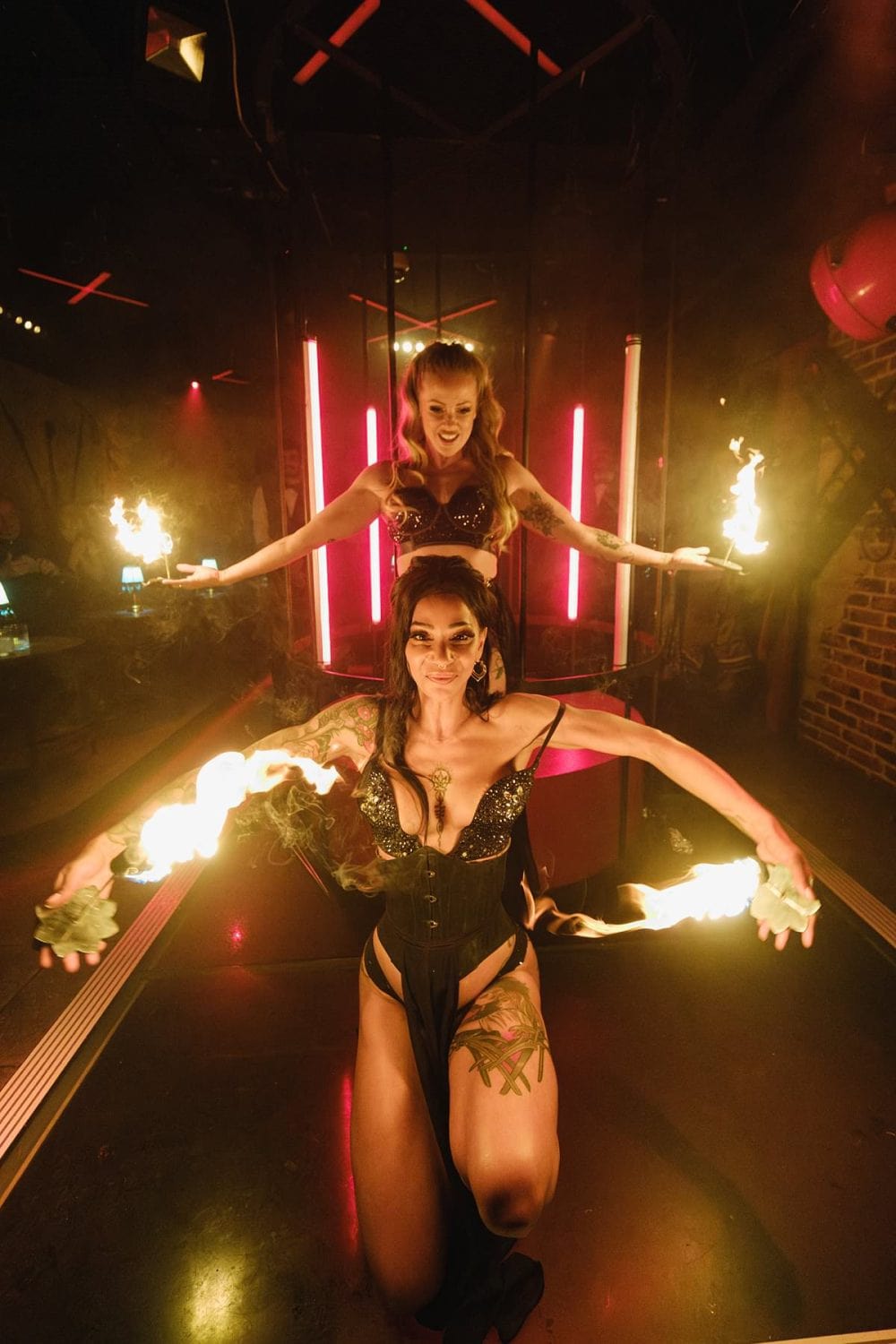 Action shot of a flame dancer entertaining guests at a Mayfair nightclub event