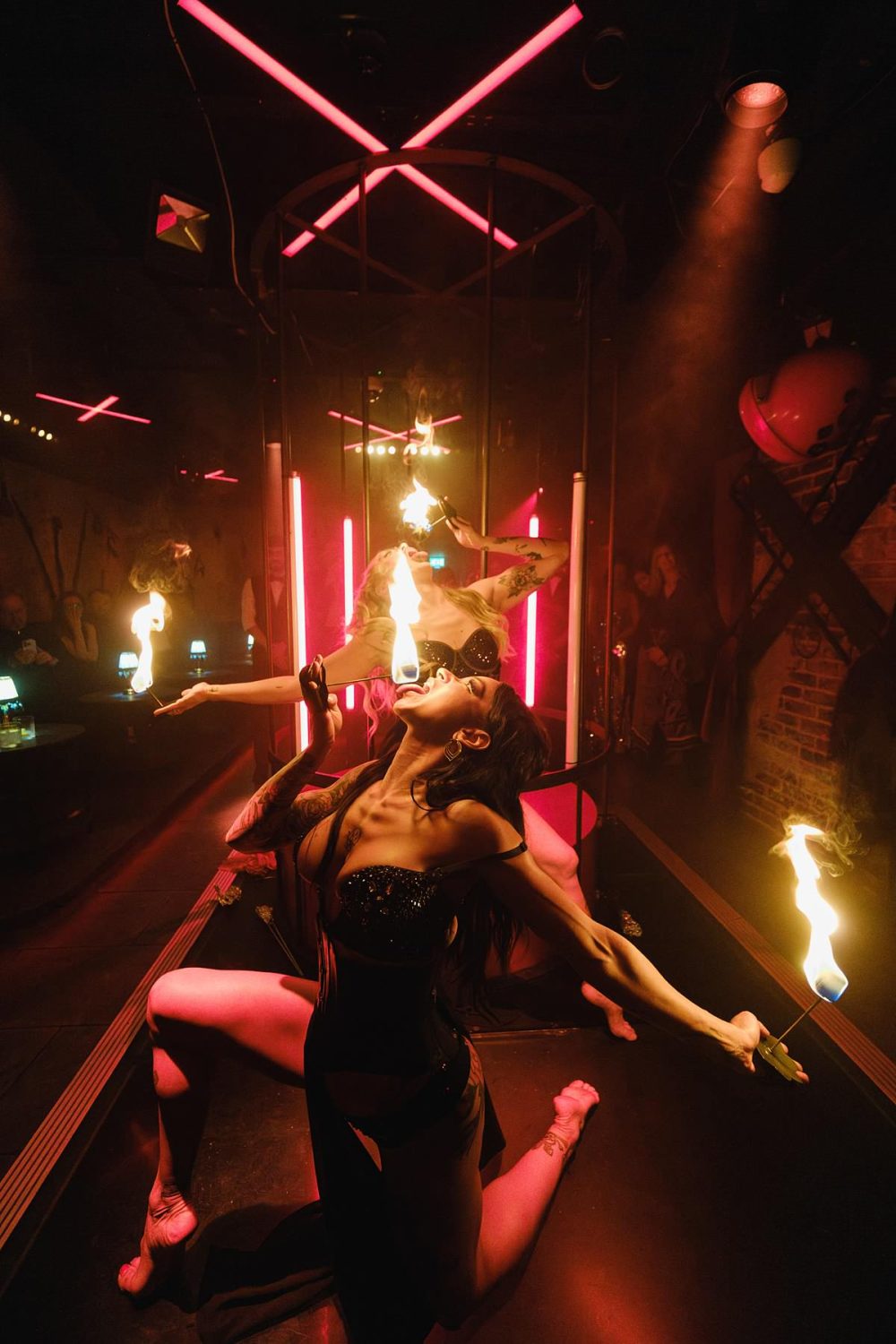Action shot of a flame dancer entertaining guests at a Mayfair nightclub event