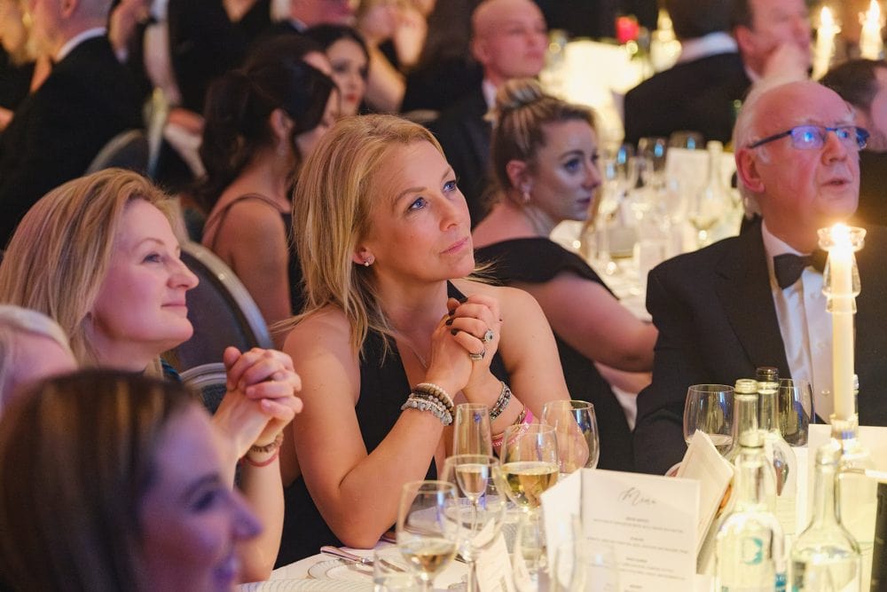 Sarah Beeny listens to a guest speaker at the Alfie Boe performing at the Brain Tumour Research gala in the ballroom at The Dorchester, London