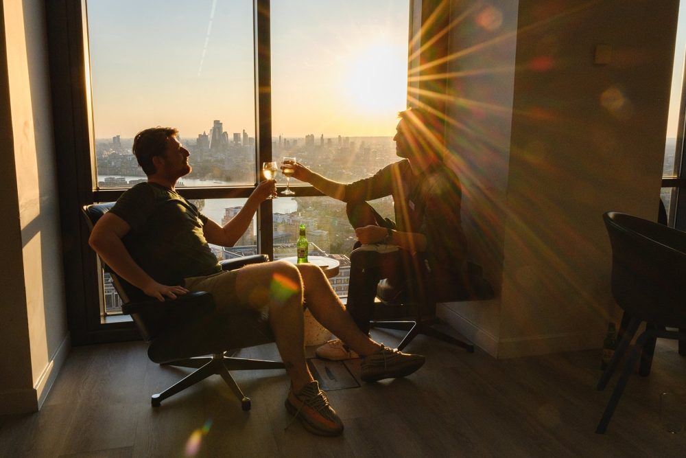 guests enjoying drinks and the sunset view from level39 in canary wharf during a networking event