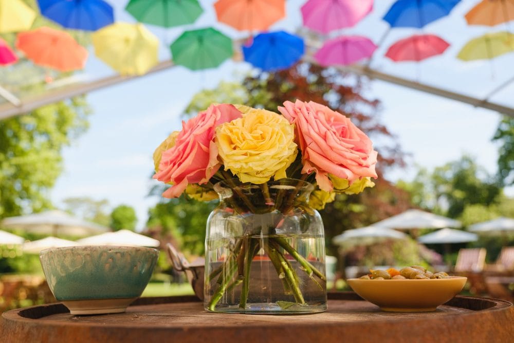 Closeup of flowers and décor under the covered decking at summer party