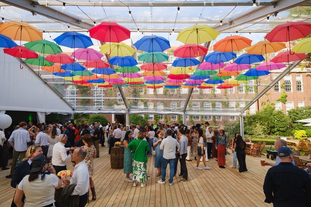 Guests socialising under marquee at Regent’s University summer event
