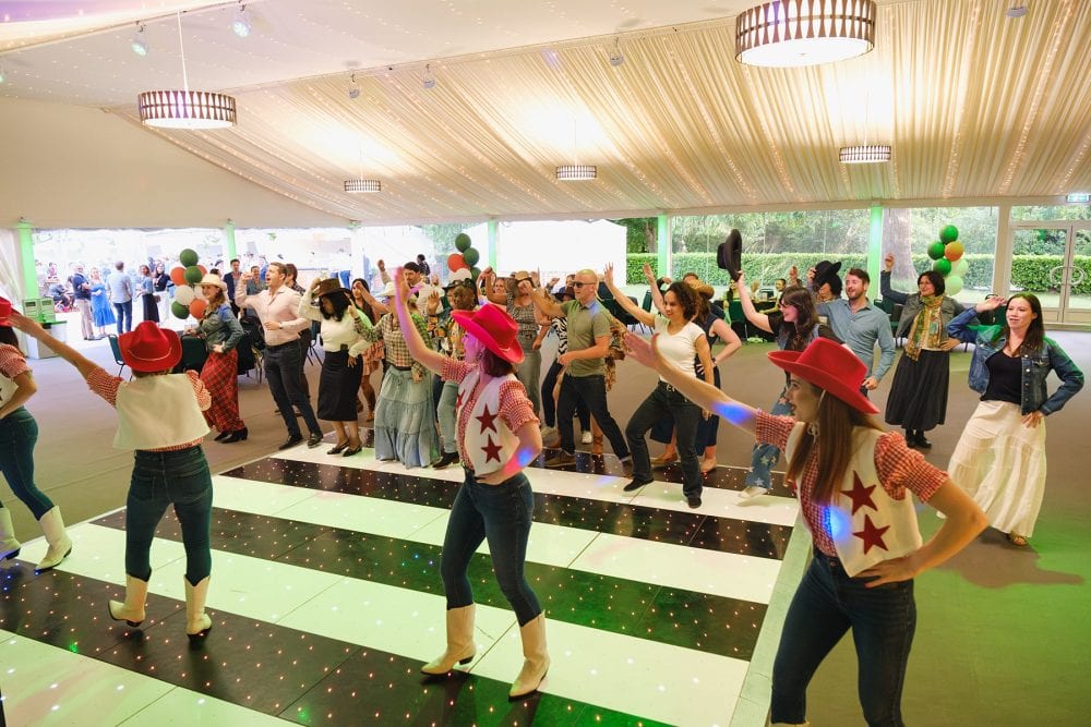 Line-dancing class in marquee during summer party at Regent’s University