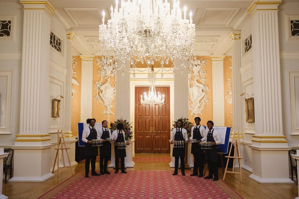 Catering staff serving drinks to guests during the Salon reception at Mansion House