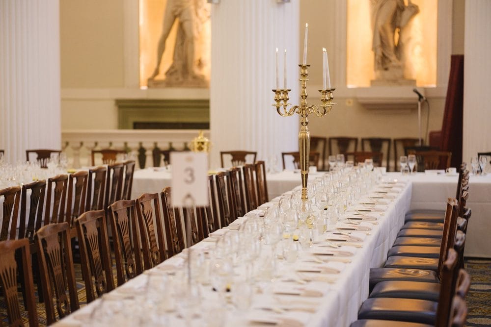 Alternate angle of table settings in the Egyptian Hall at Mansion House, showing place settings and decorations