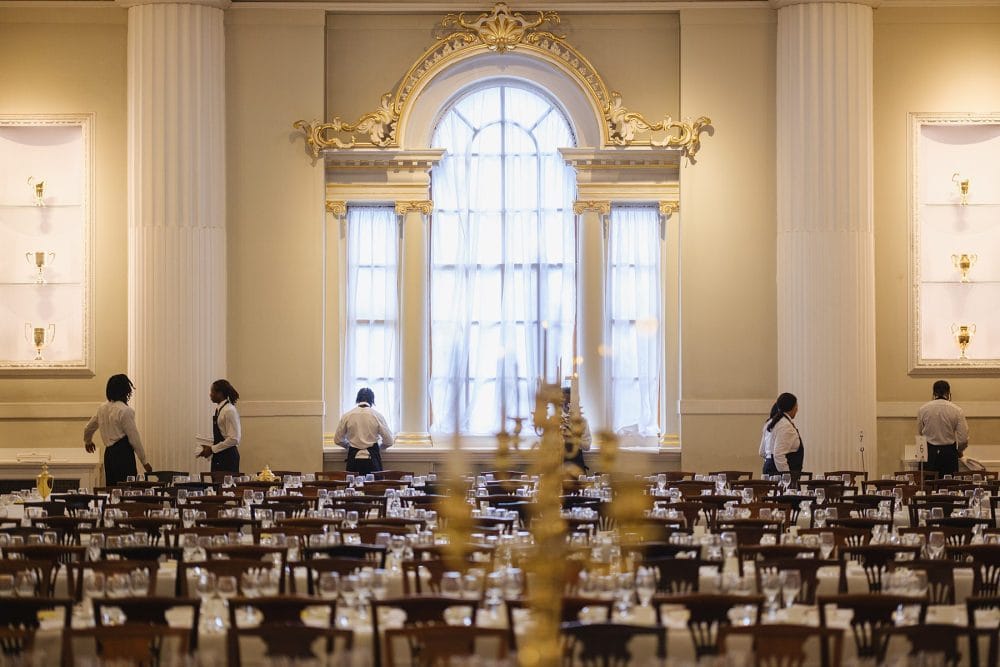 Event staff arranging chairs and décor in the Egyptian Hall at Mansion House before guests arrive
