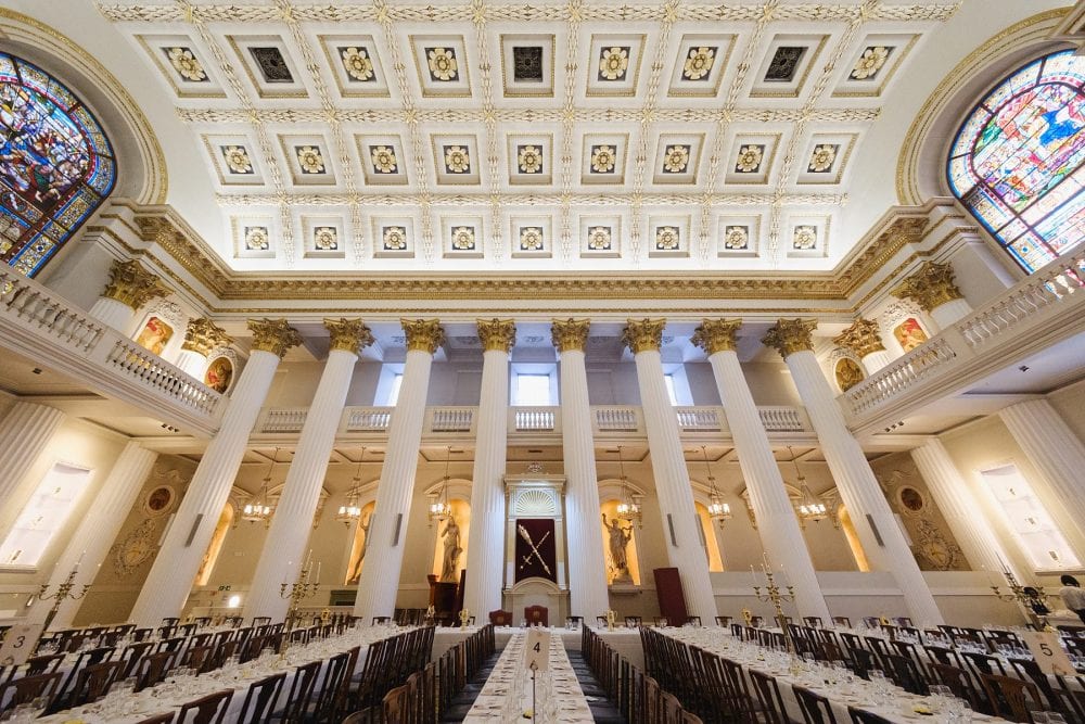 Ground-level wide shot of the Egyptian Hall at Mansion House, showing tables and columns