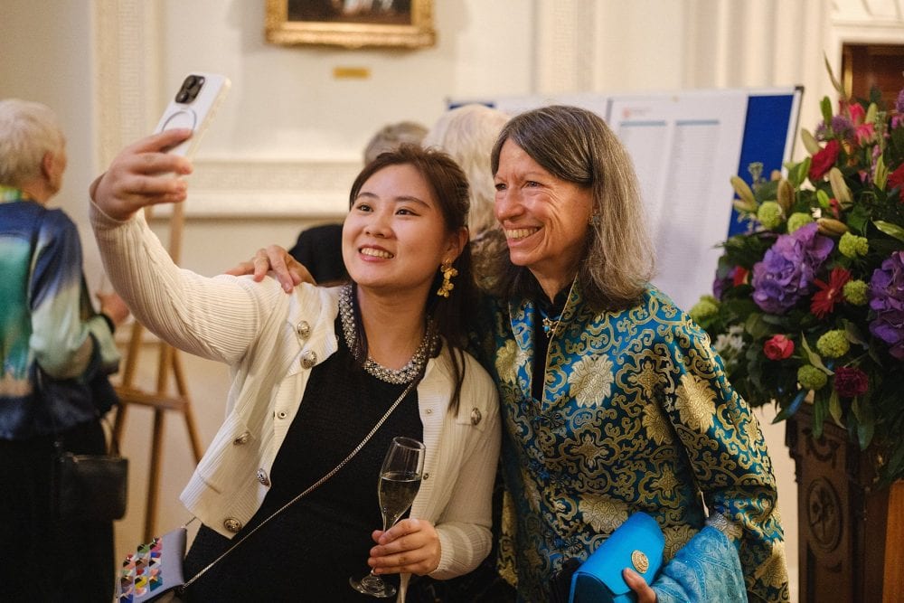 Candid photo of guests taking a selfie and laughing in the Mansion House Salon