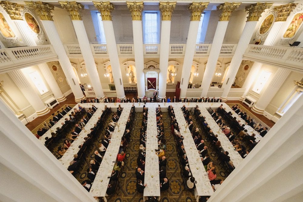 A wide overhead shot from the balcony during a dinner event in the Egyptian Hall at Mansion House