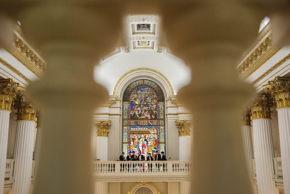 College men’s choir performing from the balcony in the Egyptian Hall at Mansion House