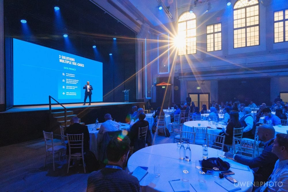 Sunlight pours into the room in a wide-angle view of the main hall during a Vision Hall conference