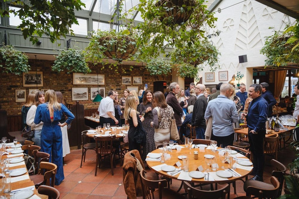 Wide shot of guests enjoying Lemonia’s private room