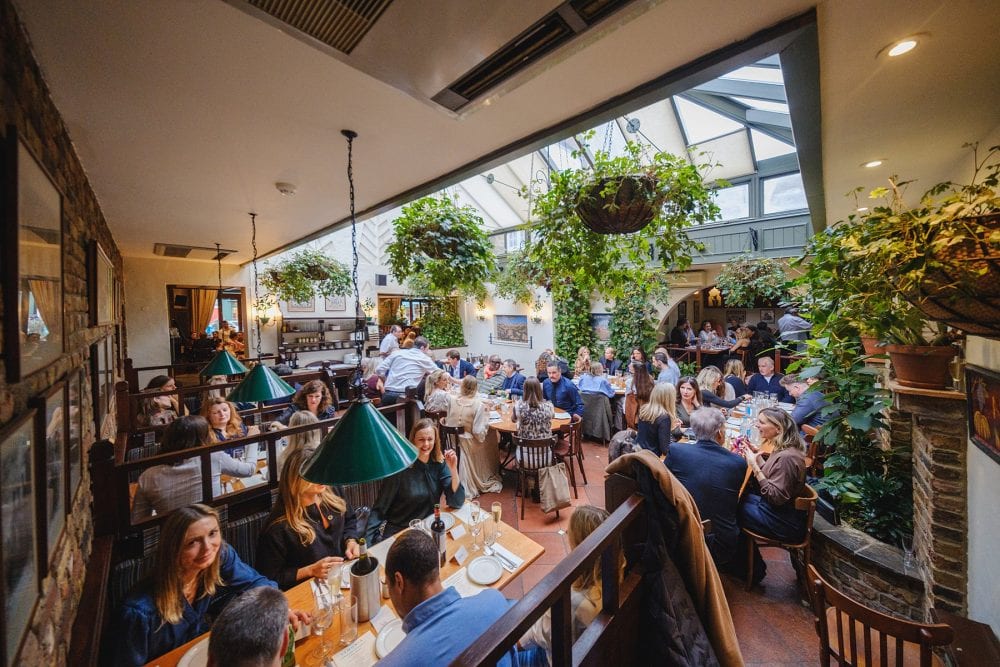 Wide shot capturing the full private dining area at Lemonia