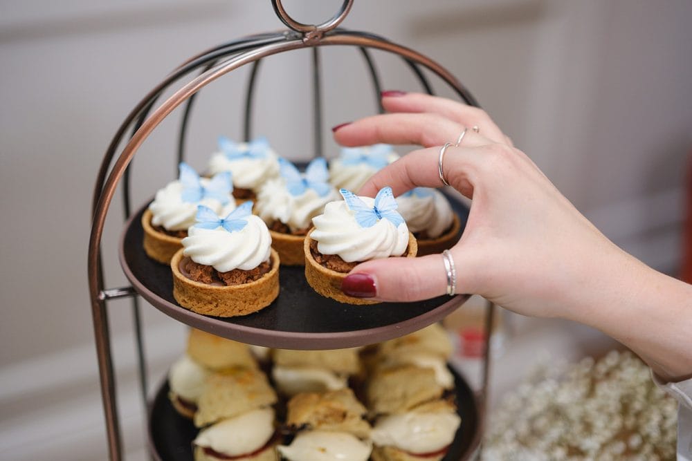 Guests enjoying cakes and treats, photographed at the event