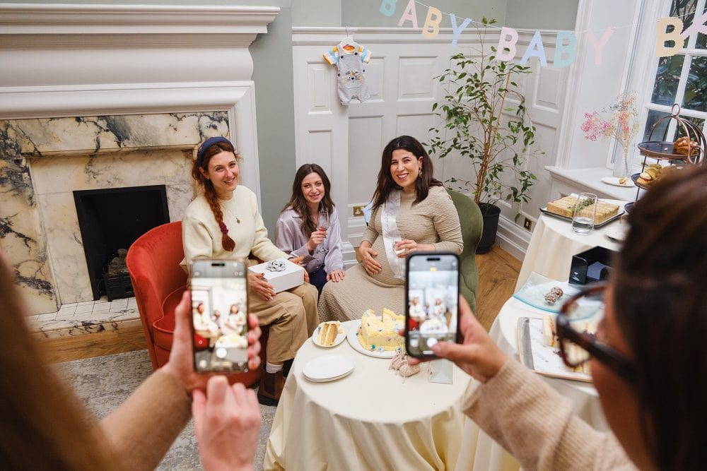 Guests capturing photos of the baby shower guest of honour