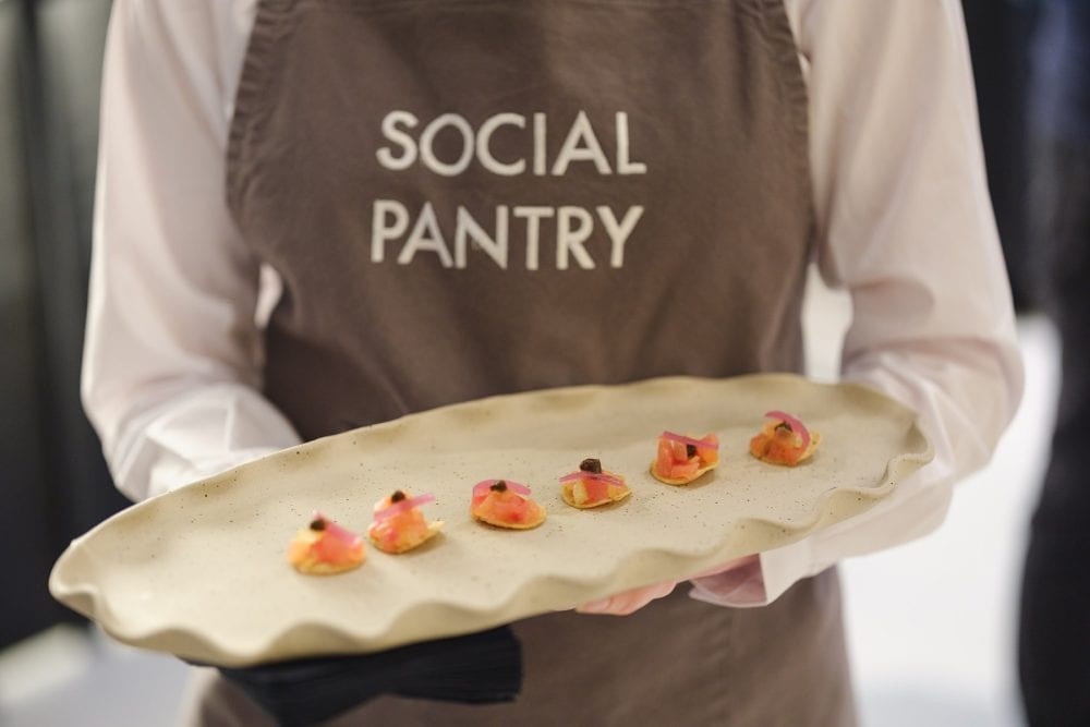 waitress holding a tray of canapes for a showroom launch party event