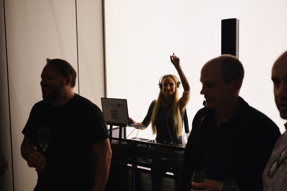 the DJ posing for the camera, photographed for a showroom launch event