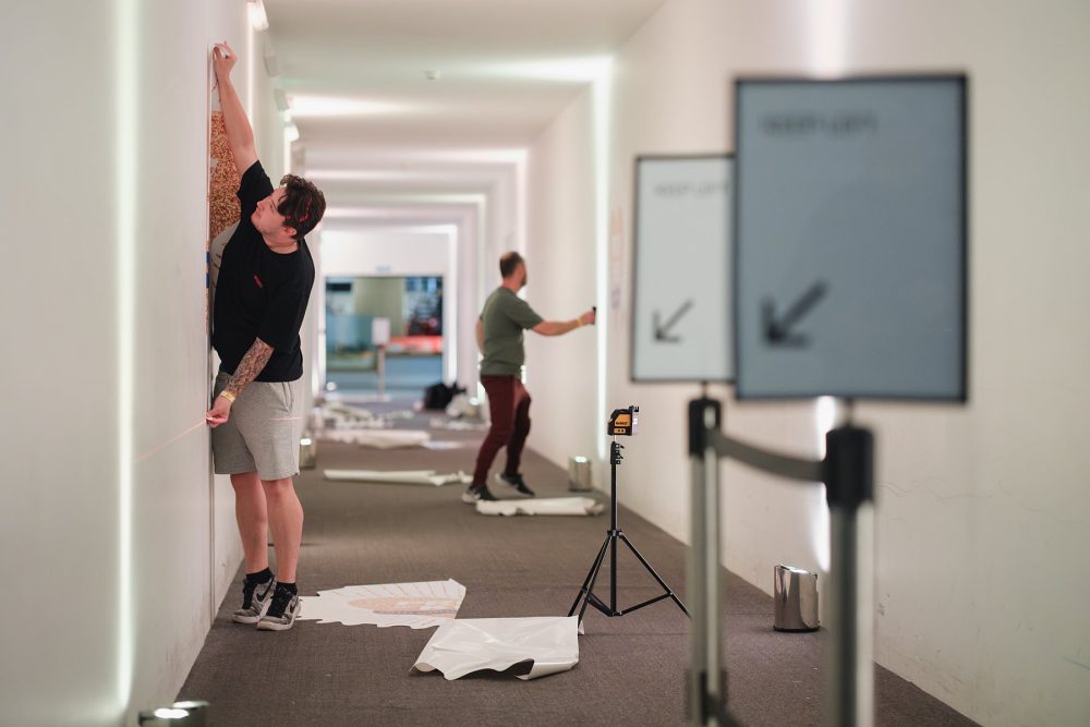 Crew setting up logos on the walls for an event at London Science Museum